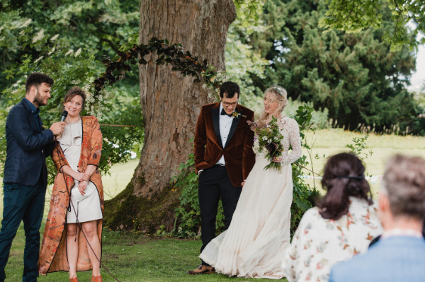 Mother of the bride gives a wedding speech at an outdoor wedding.