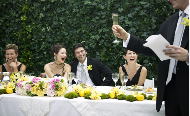 best man gives wedding speech directly to bride and groom.