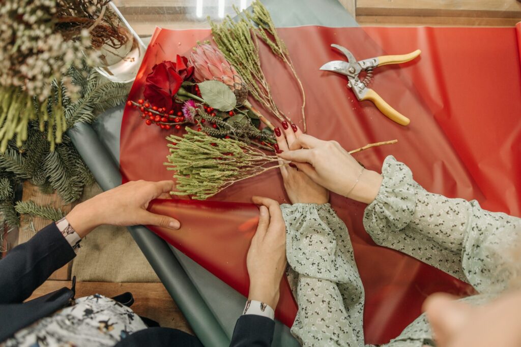 Snowy greenery with pops of saturated red flowers for a perfect winter wedding.