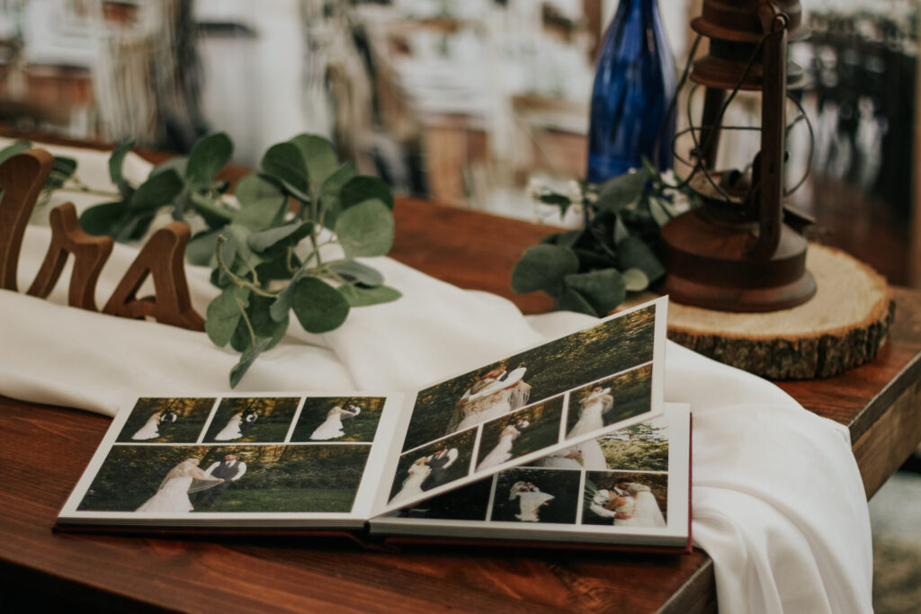 A wedding guest book, details, lantern, sitting on a table.