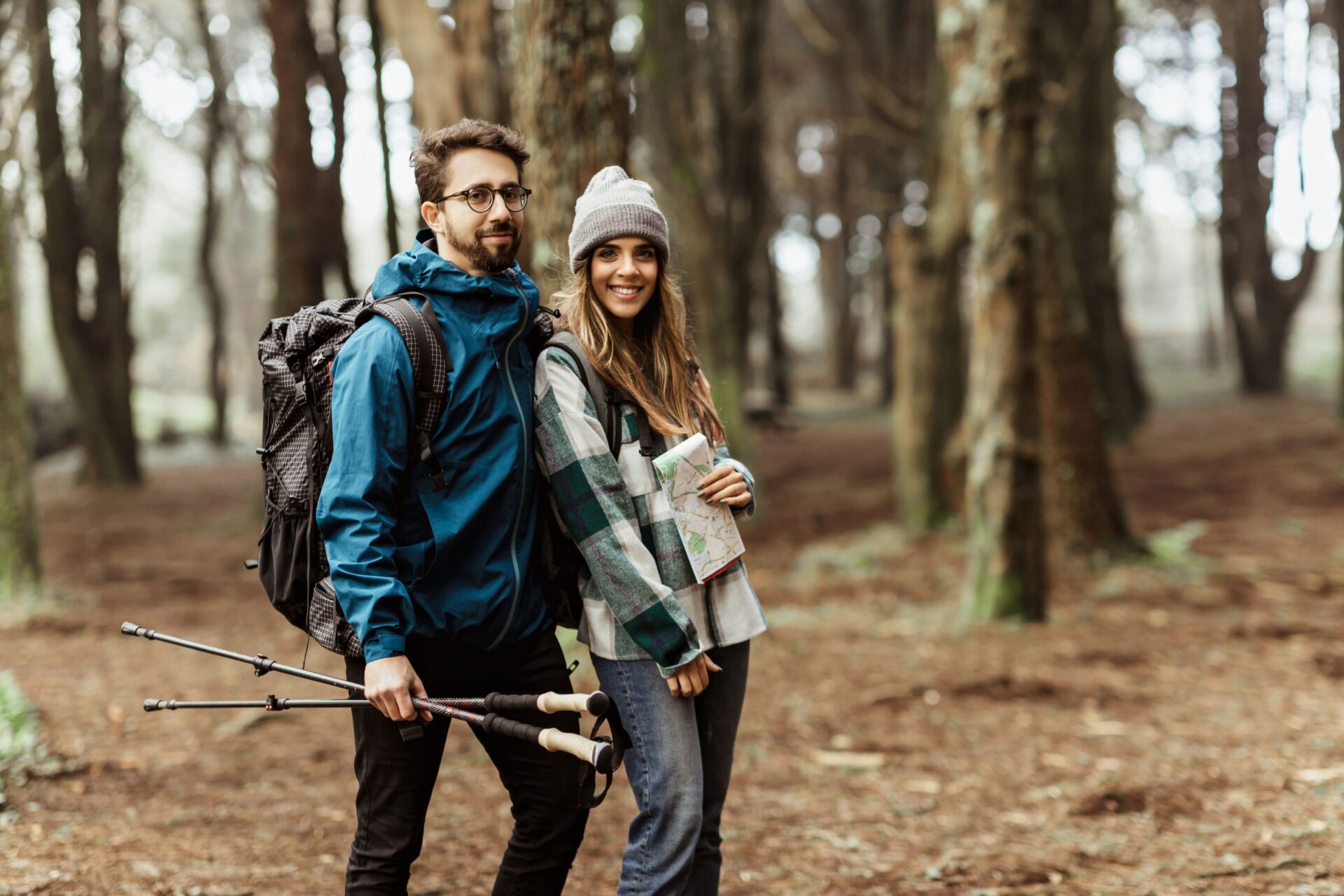 Newly wed couple in jackets with backpack, map hugging, enjoy mini-moon, walk at the North Shore.
